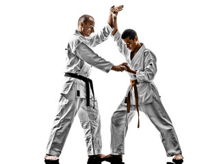 two karate men sensei and teenager student teacher teaching isolated on white background © snaptitude