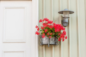Details of a flower pot at the entrance on a wooden house. Scandinavian decoration style. Sweden, Scandinavia, Europe.