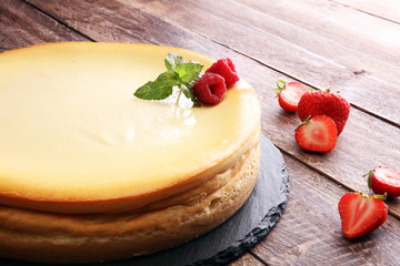 Homemade cheesecake with fresh strawberries and mint for dessert - healthy organic summer dessert pie cheesecake. Vanilla Cheese Cake.