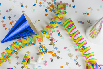 Streamers, confetti, funny hats and party horns