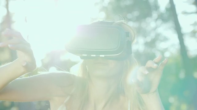 Woman in VR helmet. In the sun, beautiful lens flare