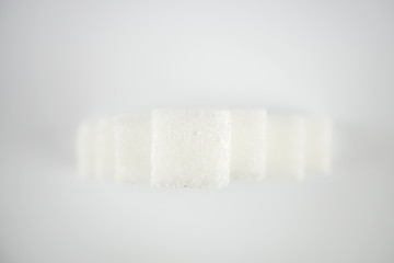 View from above on a pyramid of sugar cubes, white background