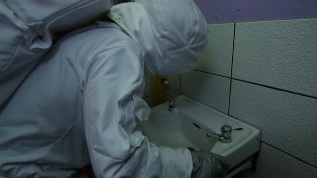  Badly behaved astronaut partying hard in nightclub, being sick in bathroom