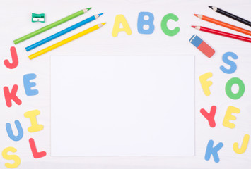 Learning how to read and write. Kid's desk with blank notebook and colorful letters, top view with copy space 