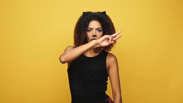 Young cheerful african woman with cat make-up and ears dancing isolated over yellow
Young cheerful african woman with cat make-up and ears dancing isolated over yellow
