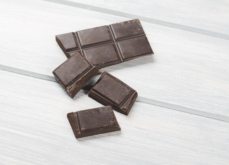 Chocolate bar on wooden table. Copy space.