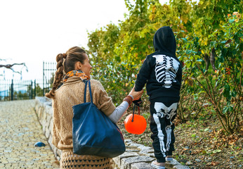 mother and daughter with Halloween pumpkin Jack O’Lantern basket playing
