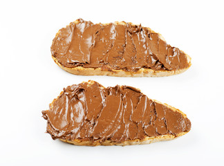 Chocolate spread on bread on white background. Isolated.