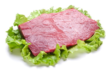 Raw meat on lettuce leaves.