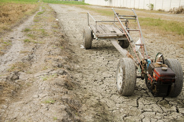 Damage old Tractor and Trailer towing stop on Paddy field wait spring season on desert land