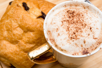 Light morning breakfast with croissant and coffee