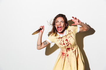 mad woman in blood splattered dress ready to attack