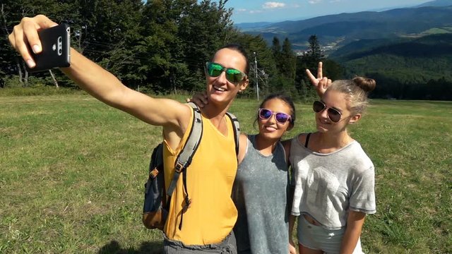 Family taking selfie with smartphone while hiking in woods, super slow motion 240fps
