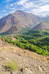 View on beautiful High Atlas Mountains landscape with lush green valley and rocky peaks, Morocco, North Africa