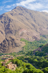 Fototapeta na wymiar View on beautiful High Atlas Mountains landscape with lush green valley and rocky peaks, Morocco, North Africa