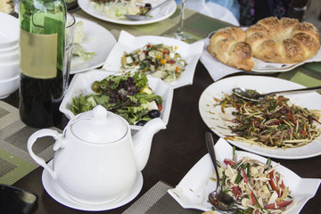 A variety of salads and a glass of dry wine - an integral part of a good dinner