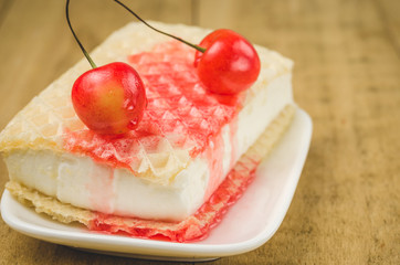 cherry and wafer ice cream on a wooden background/two cherry and wafer ice cream