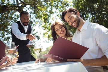 Friends placing order to waiter