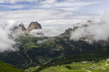 Sassolungo peaks among the clouds. Dolomites. Italy.