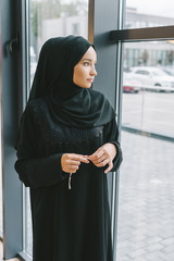 muslim woman looking at window