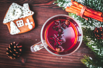cup with christmas mulled wine on wooden background top view