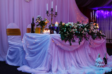 Wedding table in the restaurant with flower composition