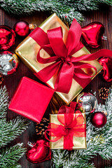 gifts boxes with fir branches on wooden background top view