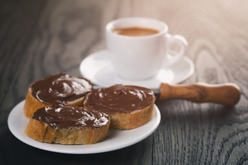breakfast with espresso and baguette slices with chocolate spread