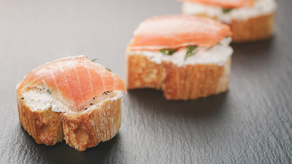 small sandwiches with soft cheese and salmon