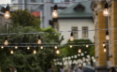 Light bulbs in a garden - summer party and culture concept