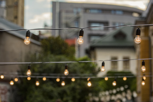 Light bulbs in a garden - summer party and culture concept