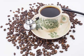 Concept roasted coffee beans, hot coffee and stethoscope isolated white background