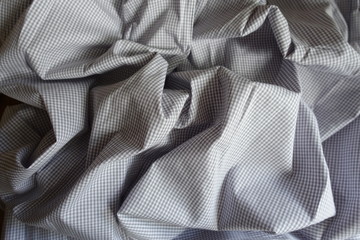Folded light grey classic chequered cotton fabric