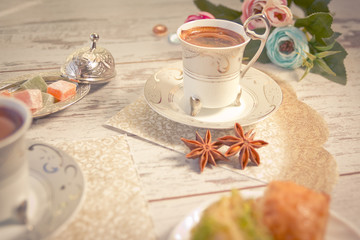 Two cups of Turkish coffee and a plate with baklava