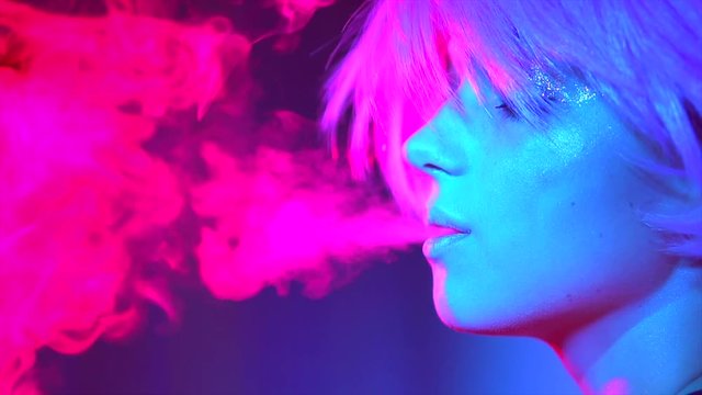 Beauty model woman in bright lights with colorful smoke. Slow motion 240 fps. 4K UHD video 3840x2160