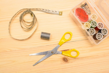Top view tailor tools on wooden background