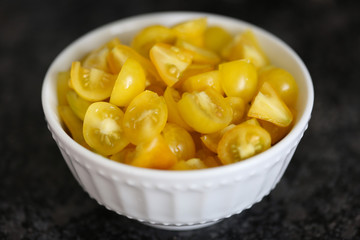 Bowl of chopped heirloom yellow pear tomatoes.