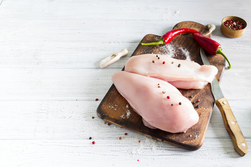 Raw chicken meat on wooden cutting