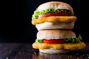 Stack of Chicken Burgers with tomatoes and lettuce.