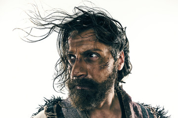 Portrait of a brutal bald-headed viking in a battle posing against a white background.