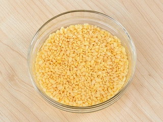 Mung bean in a glasses bowl on wooden table
