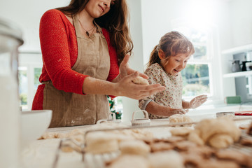 Mother and child making cookies for Christmas. - Powered by Adobe