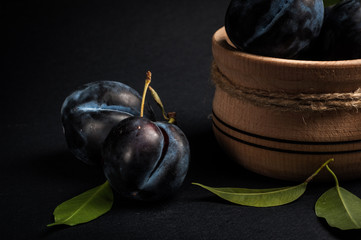 Garden plums in bowl on stone table