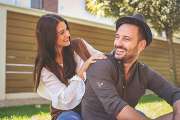 Young happy couple enjoying together in city park. Couple in nature.