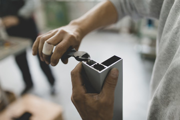 Manual worker assembling PVC doors and windows. Manufacturing jobs. Selective focus. Factory for aluminum and PVC windows and doors production.