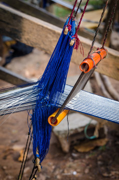 Traditional white and blue cloth for clothing being handwoven outside in Ivory Coast, West Africa
