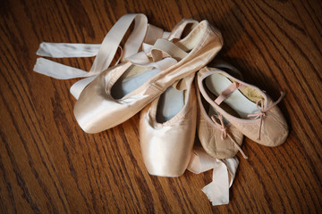 Pointe shoes with toddler sized ballet slippers.