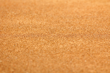 Fototapeta na wymiar Sand background focus on mid horizontal plane