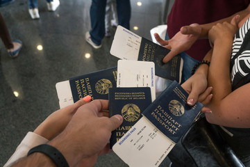 Group of Diverse Friendship Hands Show Passport with Plane Ticket