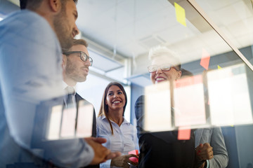 Naklejka premium Picture of designers sticking notes in office